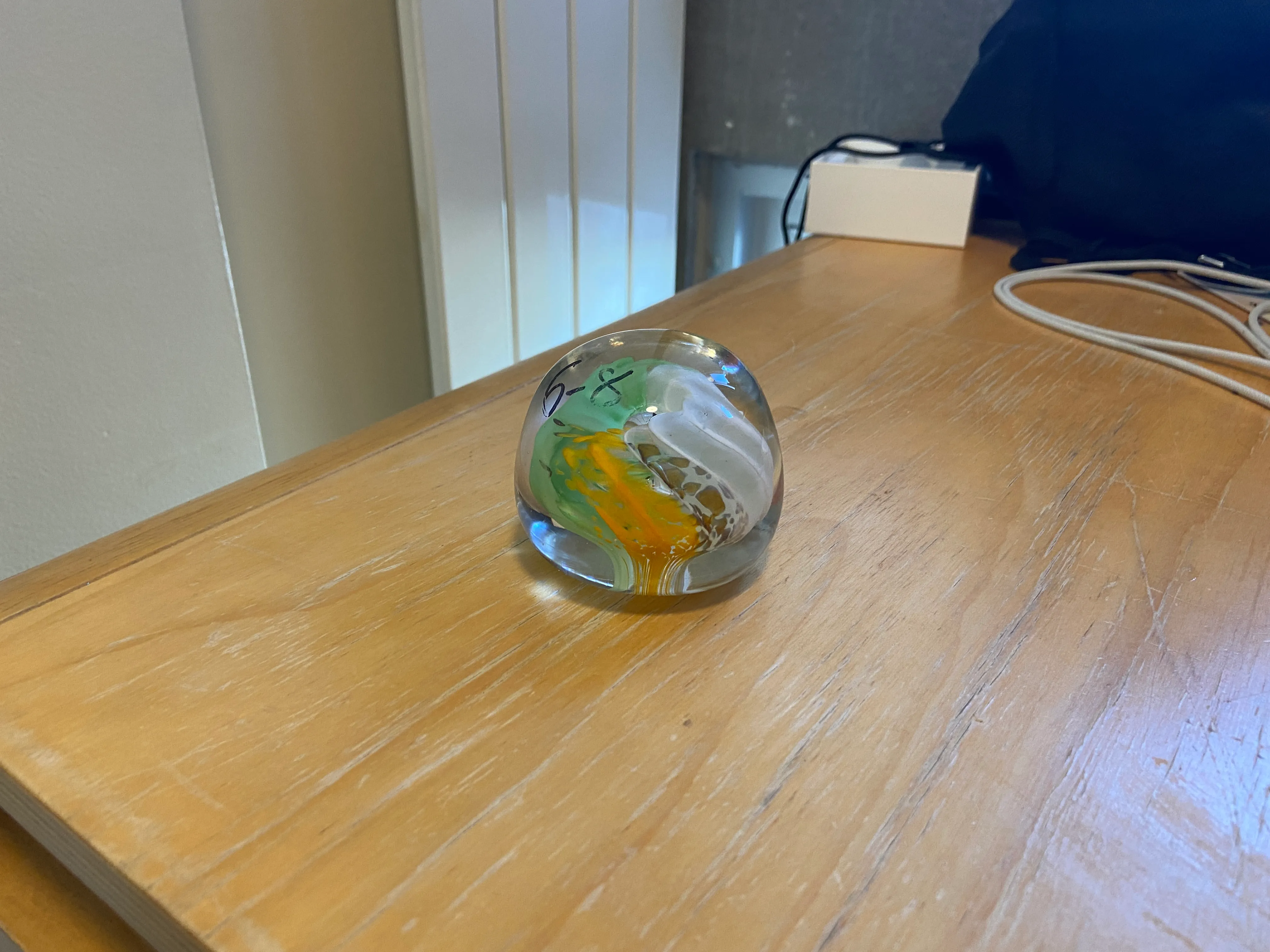 A paperweight in the Irish flag colors