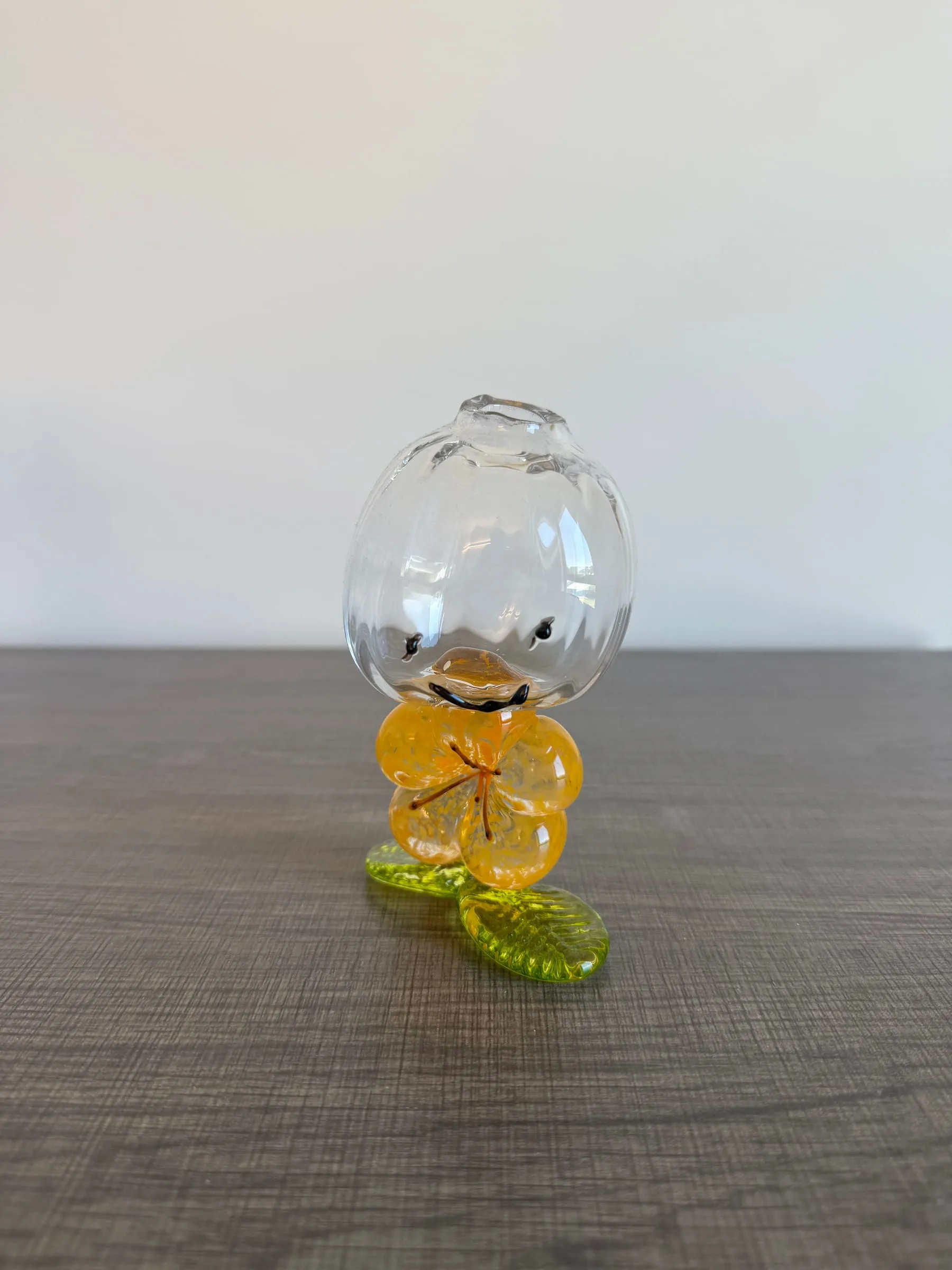 A goblet with a yellow flower on the stem